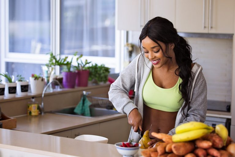 Healthy business woman slicing fruits