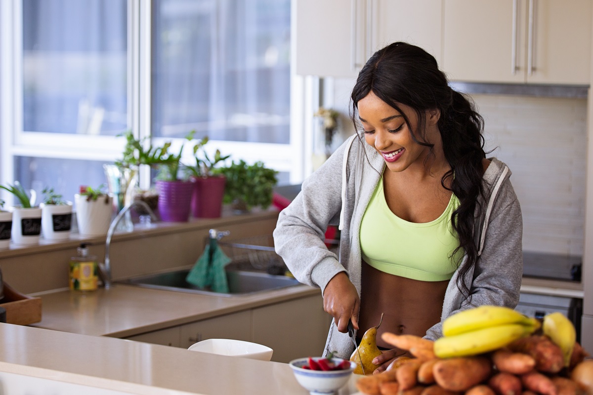 Healthy business woman slicing fruits