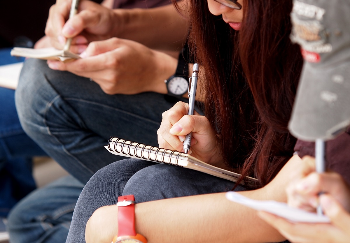 Students writing on paper