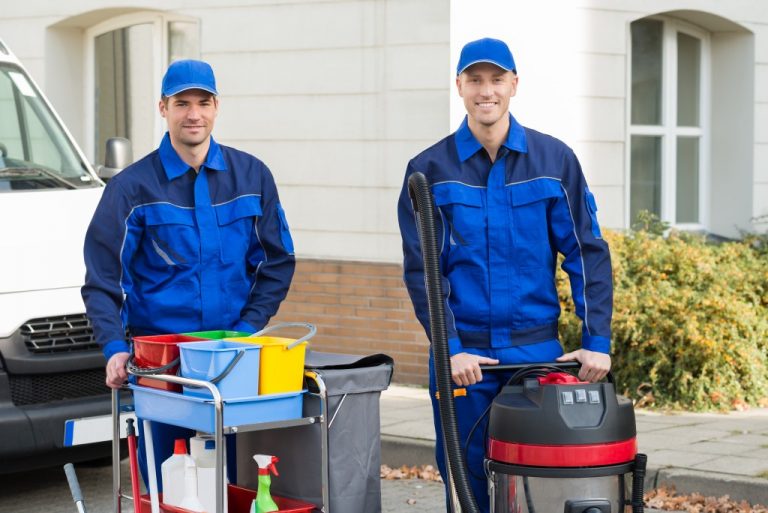 Men holding cleaning equipment