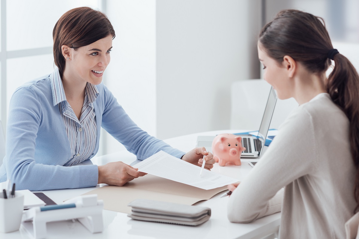 Female financial advisor explaining document to woman