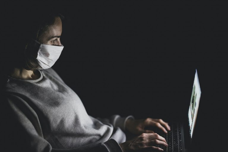 woman working while wearing face mask