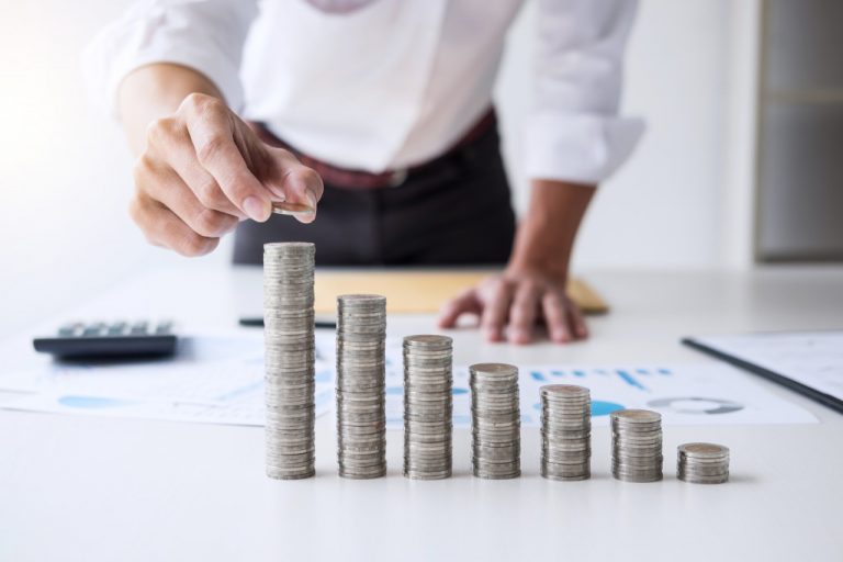 man stacking coins