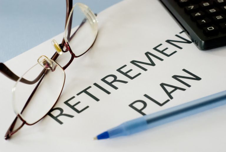 retirement plan document printed with glasses and pen